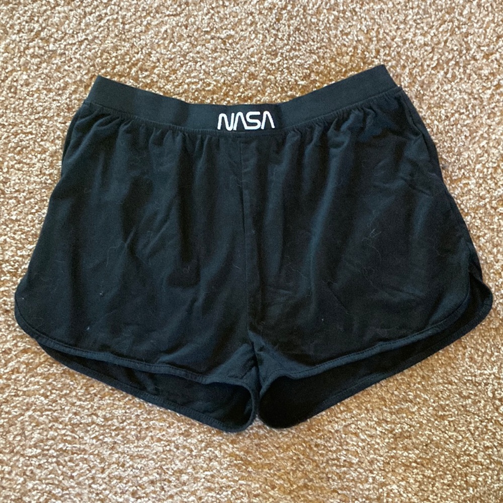 Black shorts with NASA on waistband in front